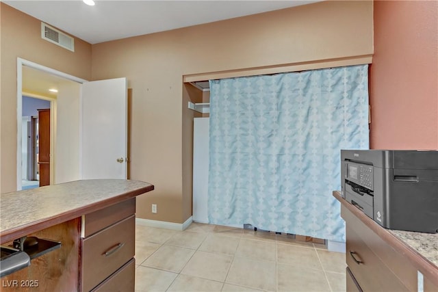 kitchen with recessed lighting, light countertops, baseboards, visible vents, and light tile patterned flooring