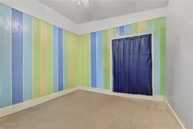 empty room with wallpapered walls and baseboards