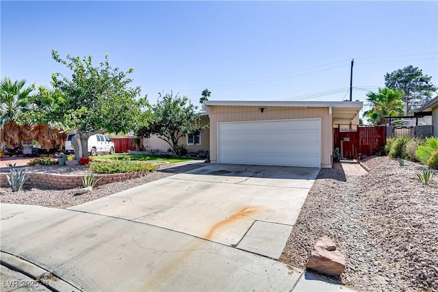 ranch-style home featuring fence and driveway