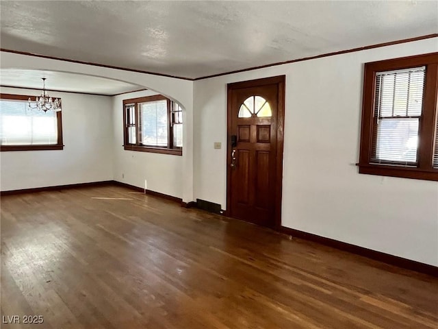 entryway with a healthy amount of sunlight, baseboards, and dark wood-style flooring