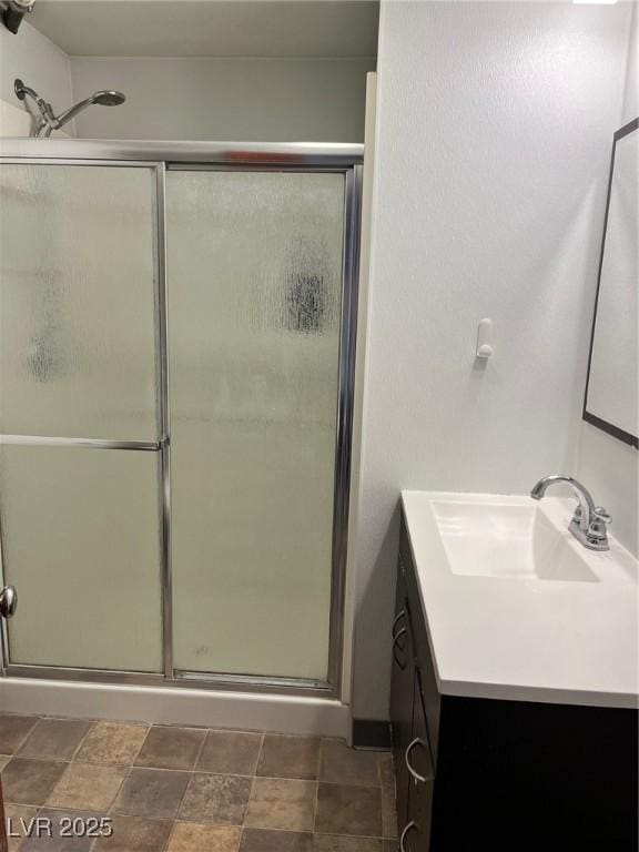 bathroom featuring a shower stall and vanity