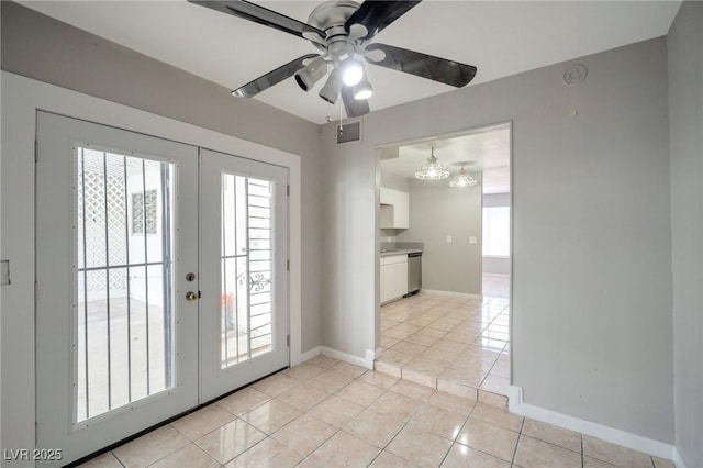 entryway with french doors, light tile patterned flooring, visible vents, and baseboards