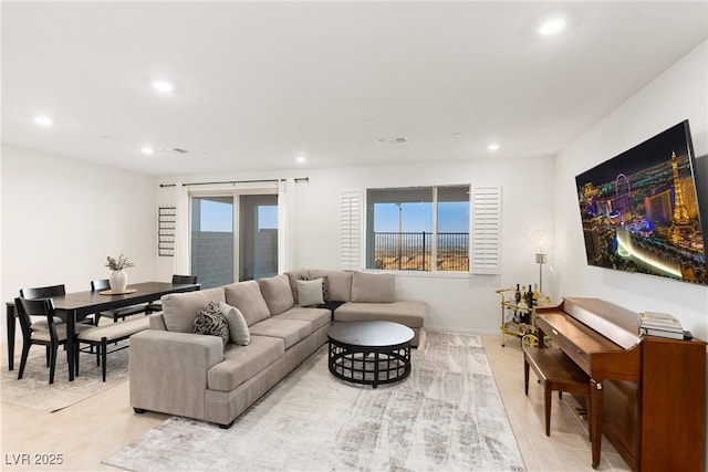 living room featuring recessed lighting and visible vents