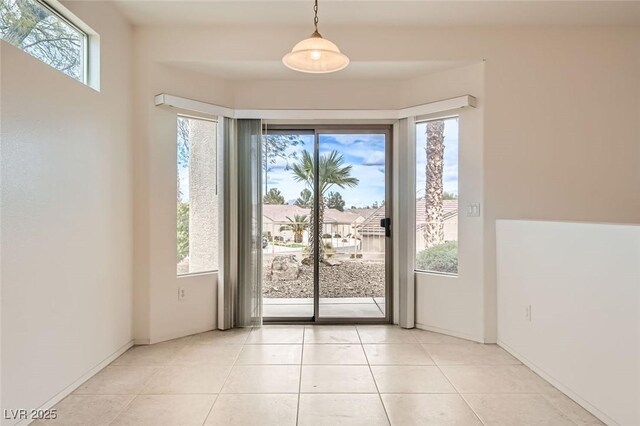 538 Cypress Gardens Pl, Henderson, NV 89012 - doorway to outside featuring light tile patterned floors, a wealth of natural light, and baseboards