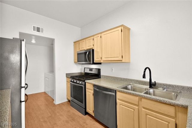 kitchen with light brown cabinets, a sink, visible vents, light countertops, and appliances with stainless steel finishes