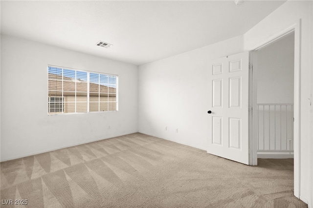 unfurnished room with light carpet and visible vents