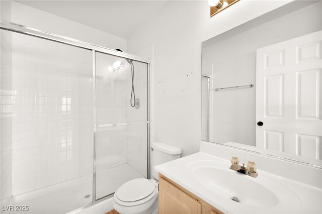 full bathroom featuring toilet, tiled shower, and vanity