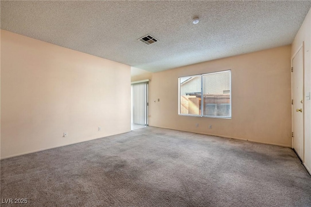 carpeted spare room featuring visible vents and a textured ceiling