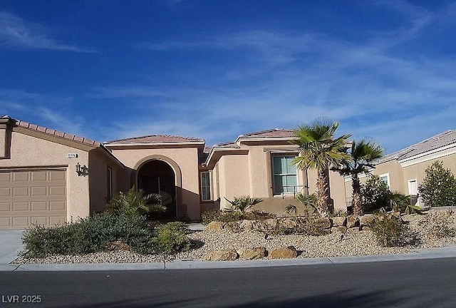 view of front facade with an attached garage and stucco siding