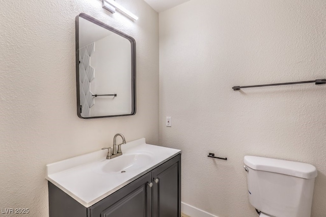 bathroom with toilet and vanity