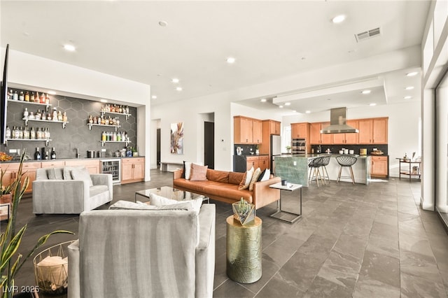 living room featuring wine cooler, visible vents, bar area, and recessed lighting