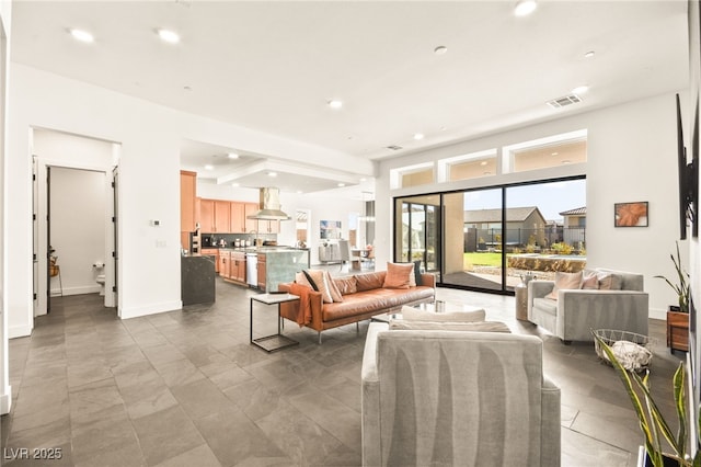 living room featuring baseboards, visible vents, and recessed lighting