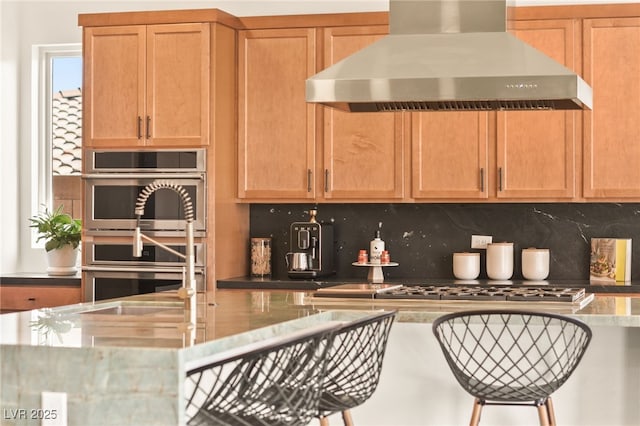 kitchen with a sink, stainless steel appliances, extractor fan, and backsplash