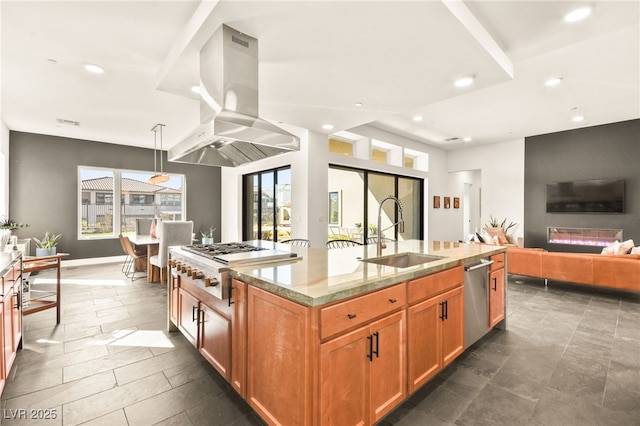 kitchen with a sink, open floor plan, an island with sink, island exhaust hood, and pendant lighting