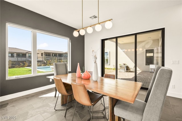 dining area with baseboards and visible vents