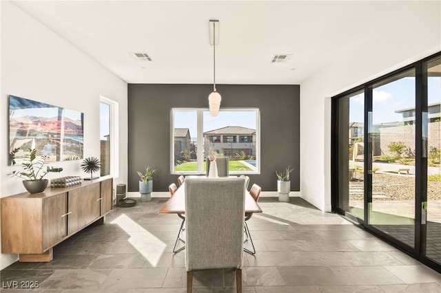 dining space featuring baseboards and visible vents