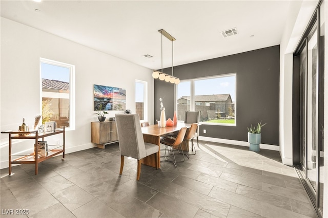 dining space with baseboards and visible vents