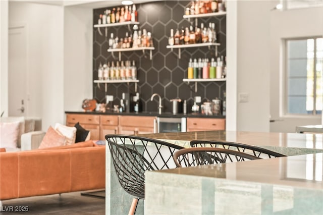 bar featuring tasteful backsplash and indoor wet bar