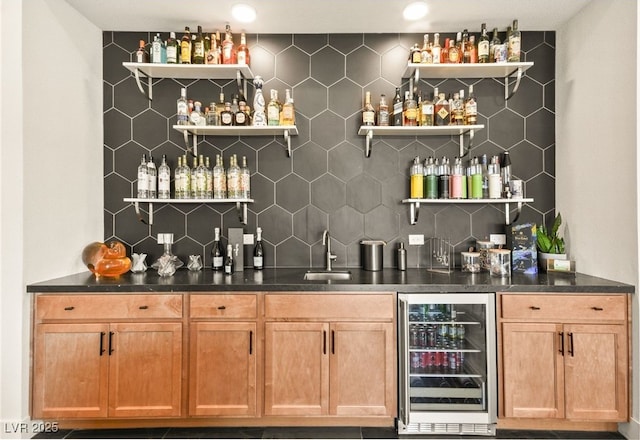 bar with wine cooler, a sink, backsplash, and wet bar