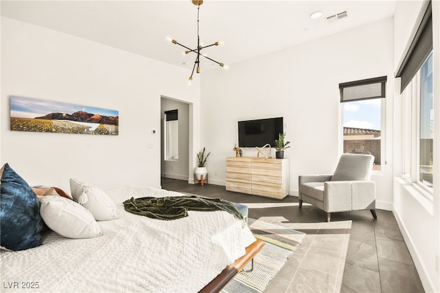 bedroom featuring a high ceiling, visible vents, a notable chandelier, and baseboards