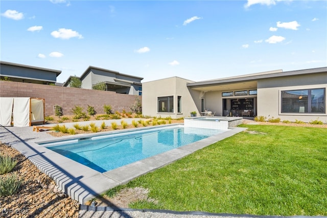 view of pool with a fenced in pool, fence, a lawn, and an in ground hot tub