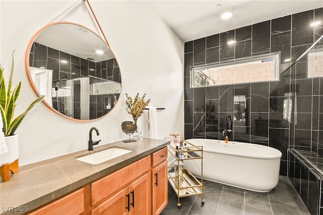 bathroom featuring tile walls, a soaking tub, a tile shower, and vanity