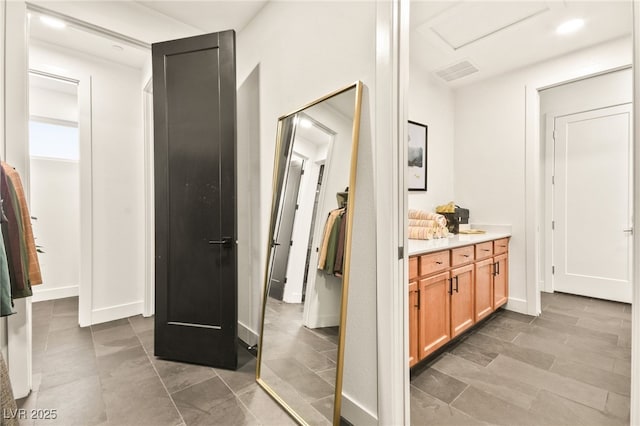 bathroom featuring visible vents, vanity, and baseboards