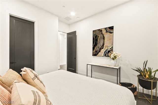 bedroom with baseboards and visible vents