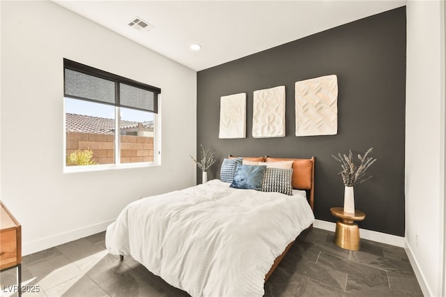 bedroom with visible vents and baseboards