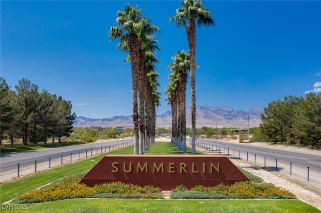 community sign with a mountain view