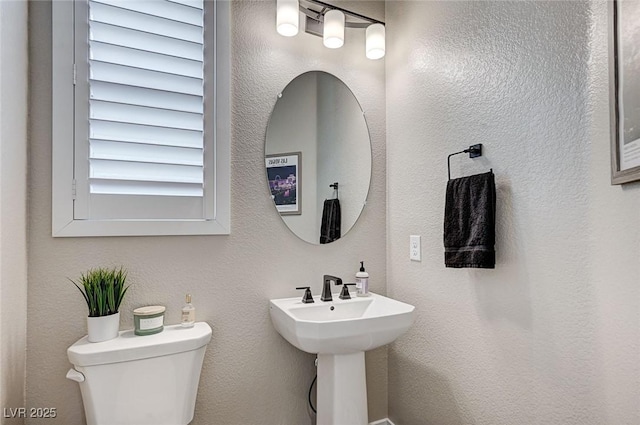 bathroom featuring toilet and a sink