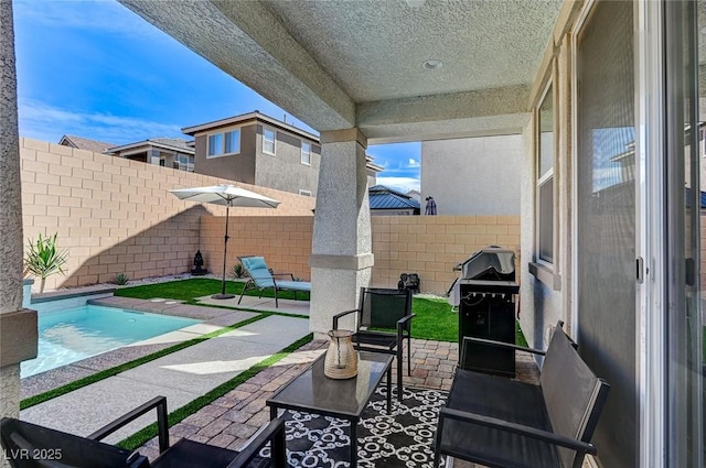 view of patio / terrace with a fenced backyard, a fenced in pool, and a grill