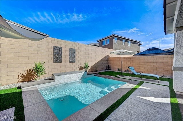 view of swimming pool featuring a patio and a fenced backyard