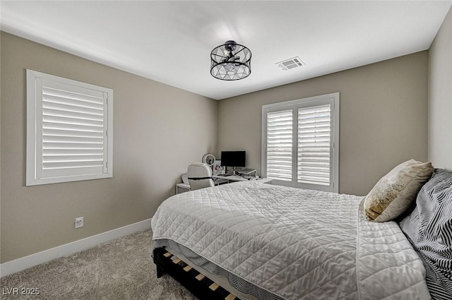 carpeted bedroom with visible vents and baseboards