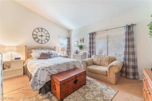 bedroom with light colored carpet and vaulted ceiling