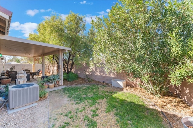 view of yard with a patio, a fenced backyard, and central air condition unit