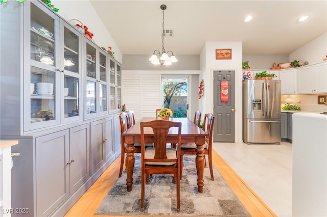 dining space featuring light wood-type flooring, visible vents, a notable chandelier, and recessed lighting