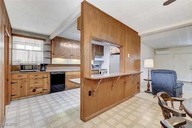 kitchen with stainless steel appliances, light floors, a wall unit AC, and light countertops