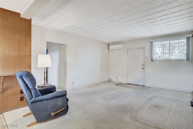 living area featuring carpet and a wall mounted AC