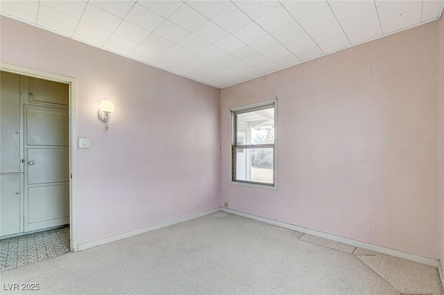 unfurnished room with light speckled floor and baseboards