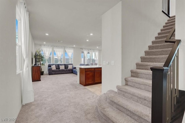 stairs featuring carpet flooring, visible vents, and recessed lighting