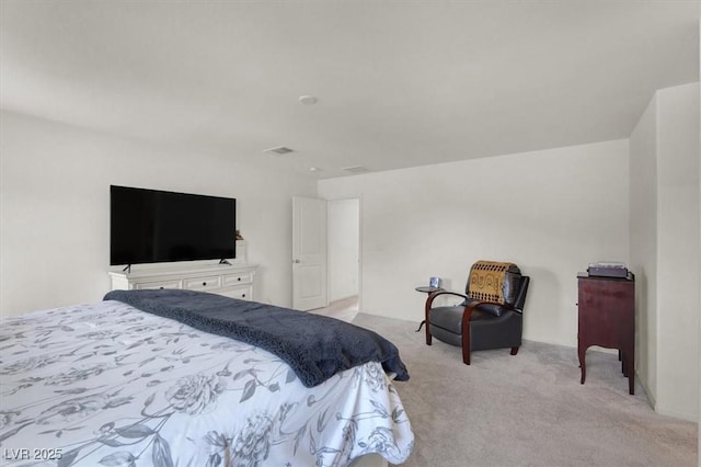 bedroom featuring visible vents and light colored carpet