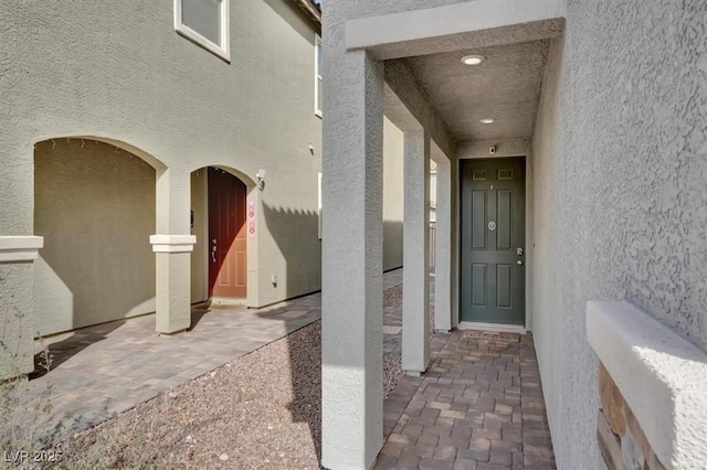 view of exterior entry with stucco siding