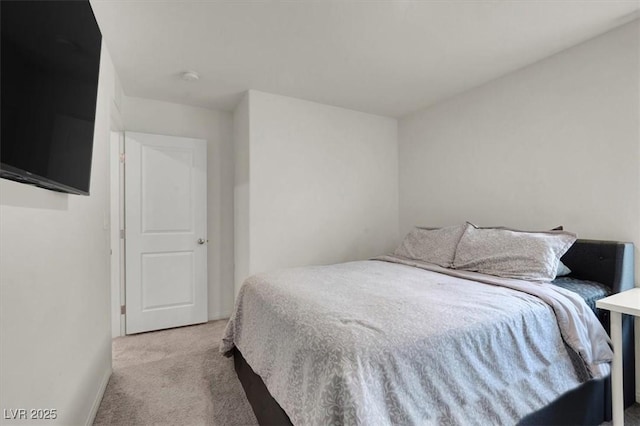 bedroom featuring light carpet and baseboards