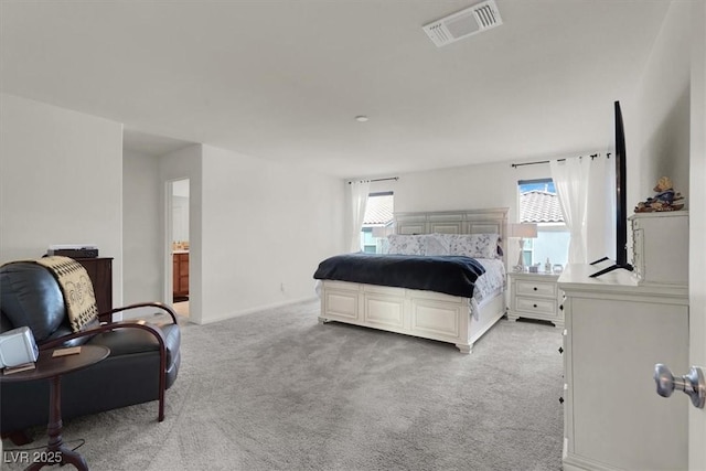 bedroom with multiple windows, visible vents, and light colored carpet