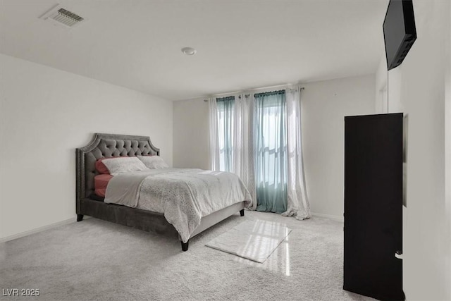 bedroom with carpet, visible vents, and baseboards