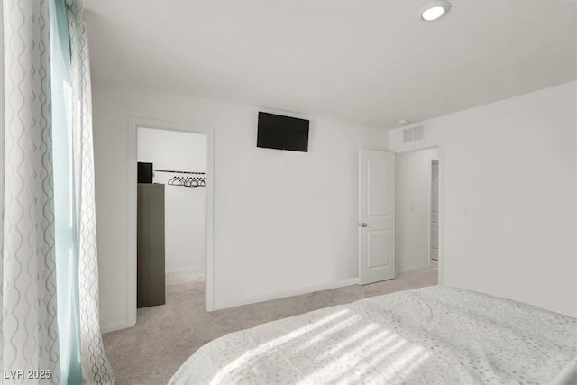 bedroom with light colored carpet, visible vents, and baseboards