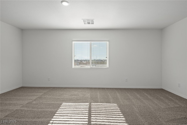 carpeted empty room with visible vents and baseboards