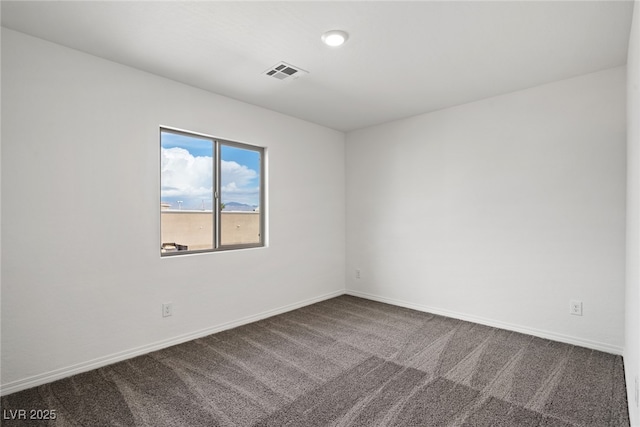 carpeted empty room featuring baseboards and visible vents