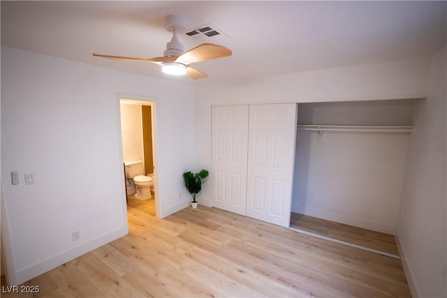 unfurnished bedroom with connected bathroom, visible vents, baseboards, a closet, and light wood finished floors